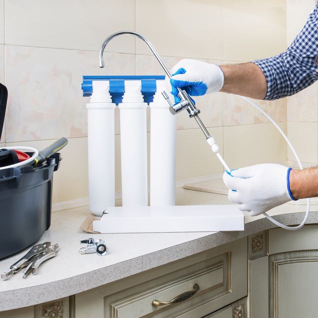 Wasserfiltersystem wird von Handwerker installiert